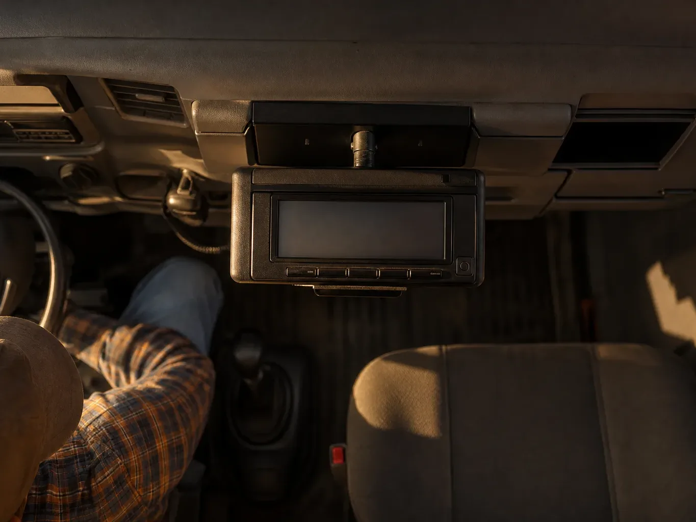 An electronic logging device is mounted inside a truck cab